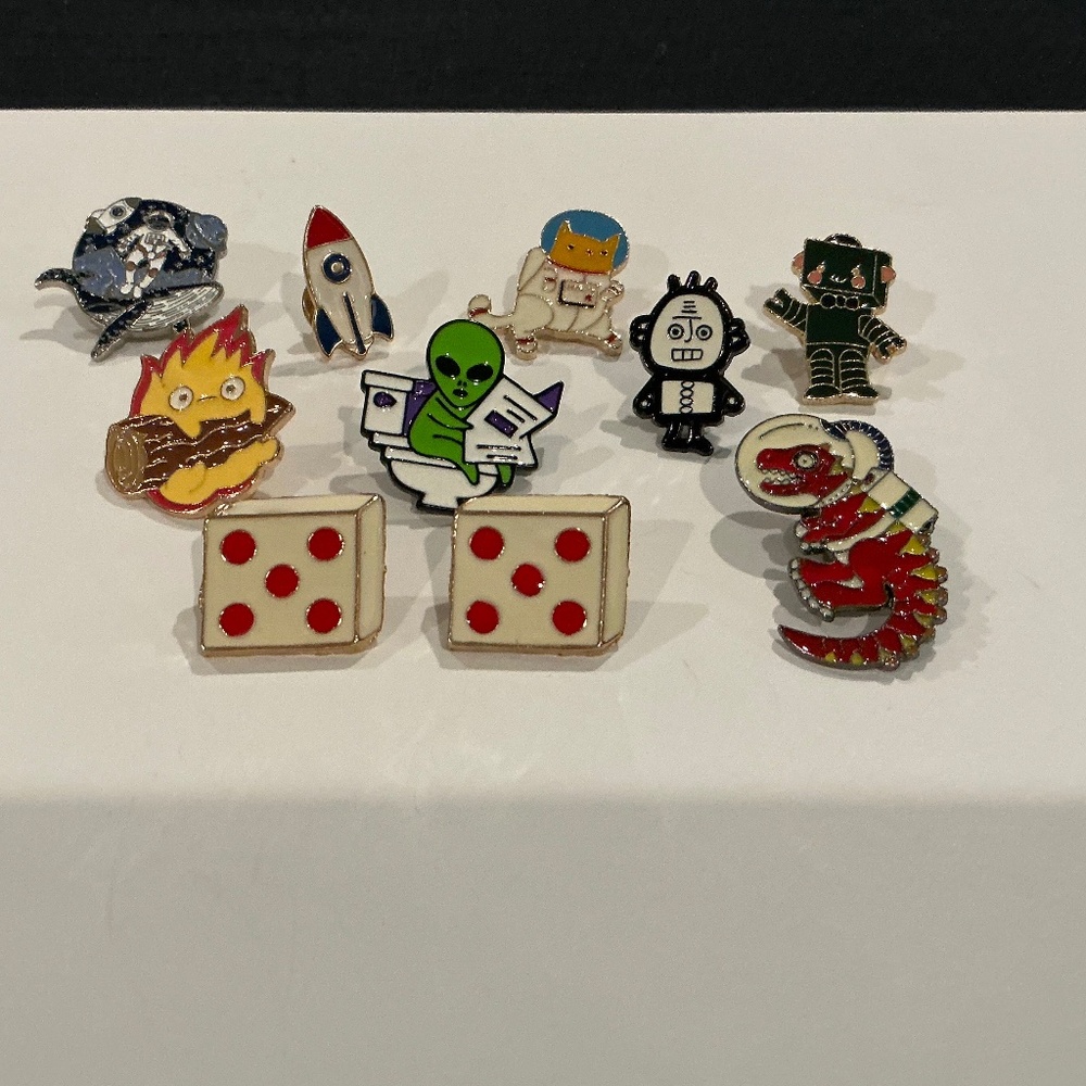 10 tac pins MAN, CAT, ALLIGATOR IN SPACE, ROCKET, ROBOTS, ALIEN, FIRE, DICE